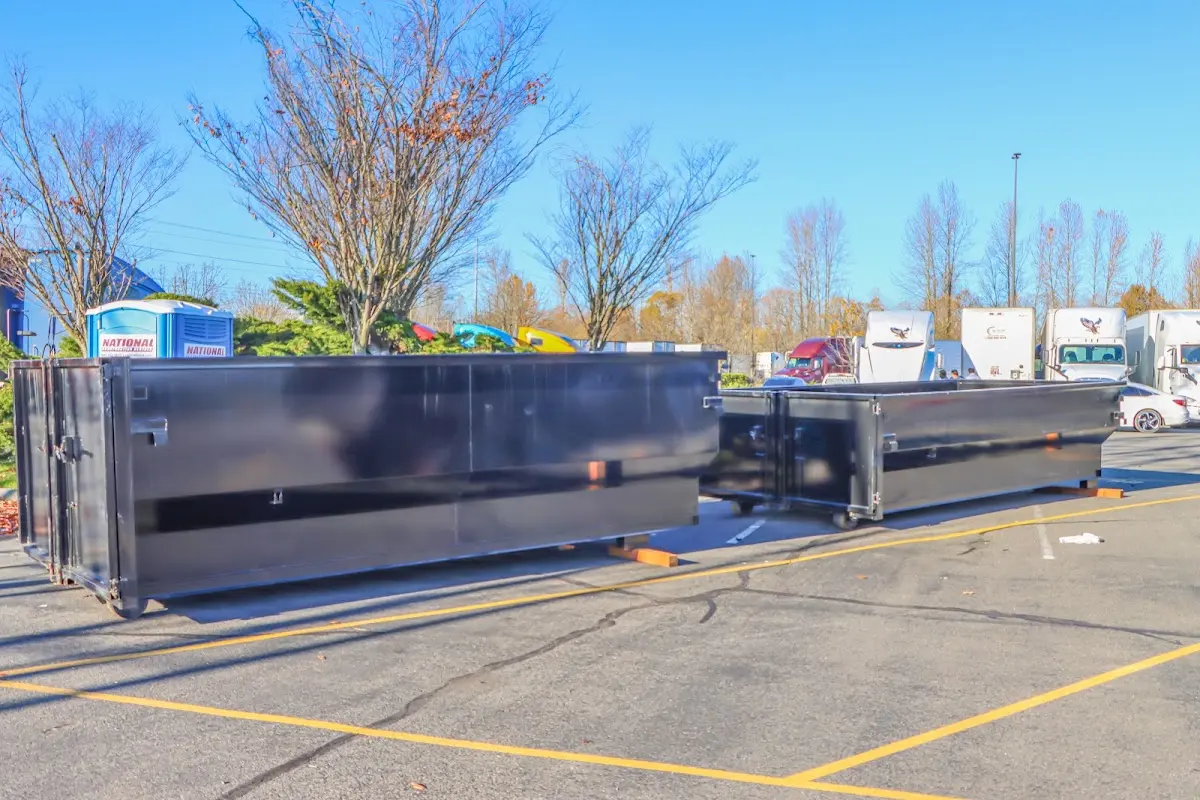 Professional dumpster rental service with roll-off container on residential driveway in Altoona